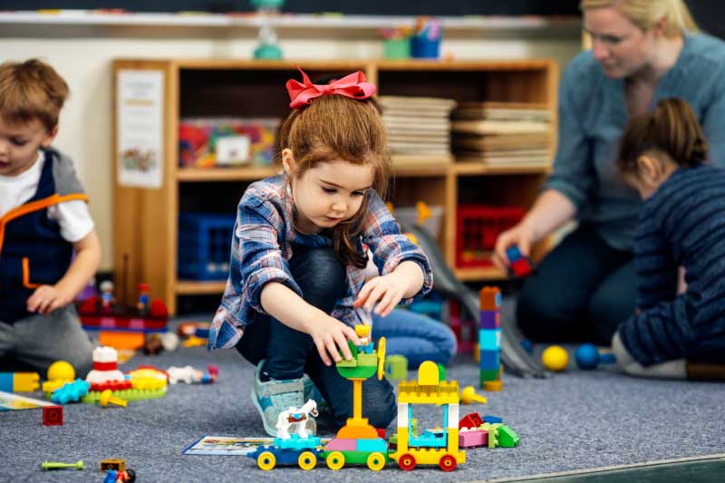 Little girl building lego