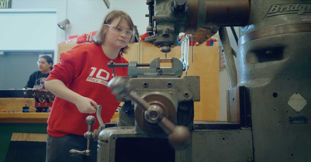 Girl working a drill press