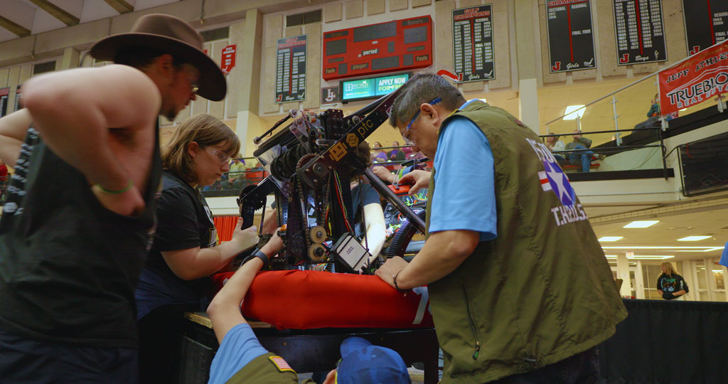 Mentors working on a robot