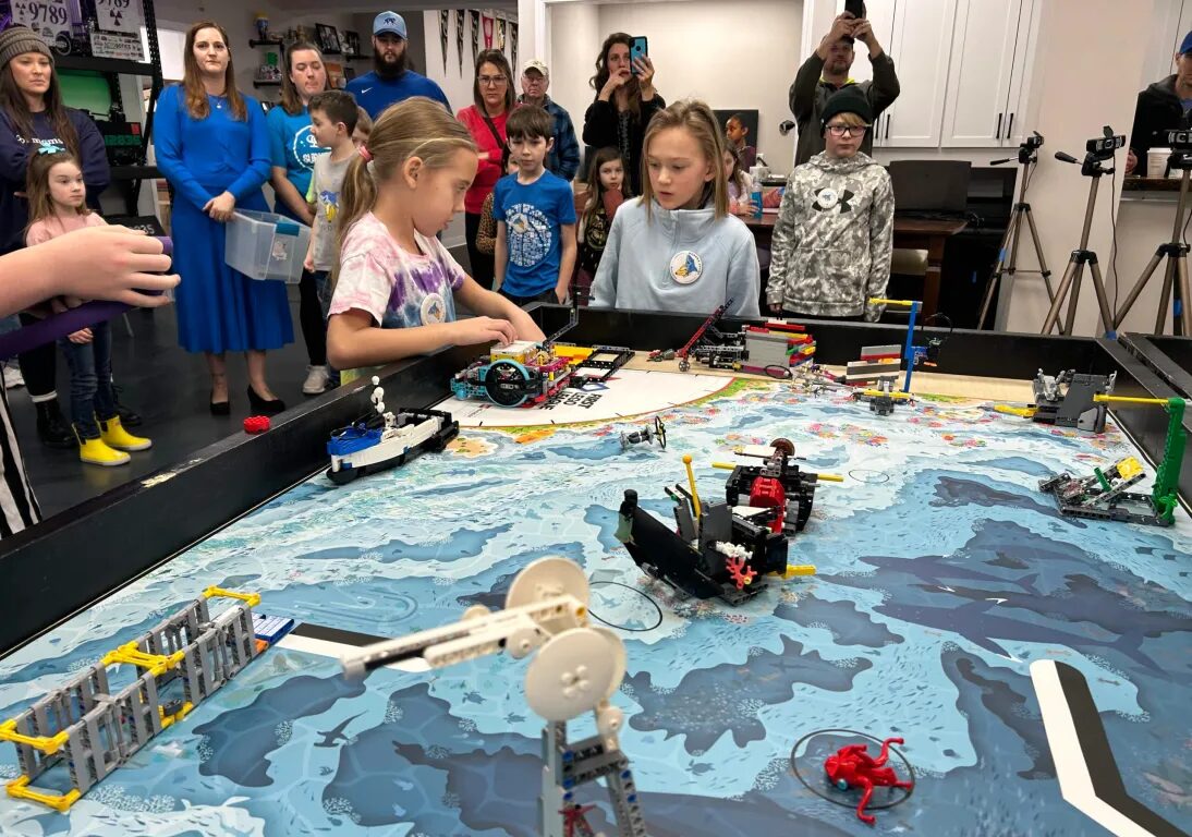 Two girls competing with legos