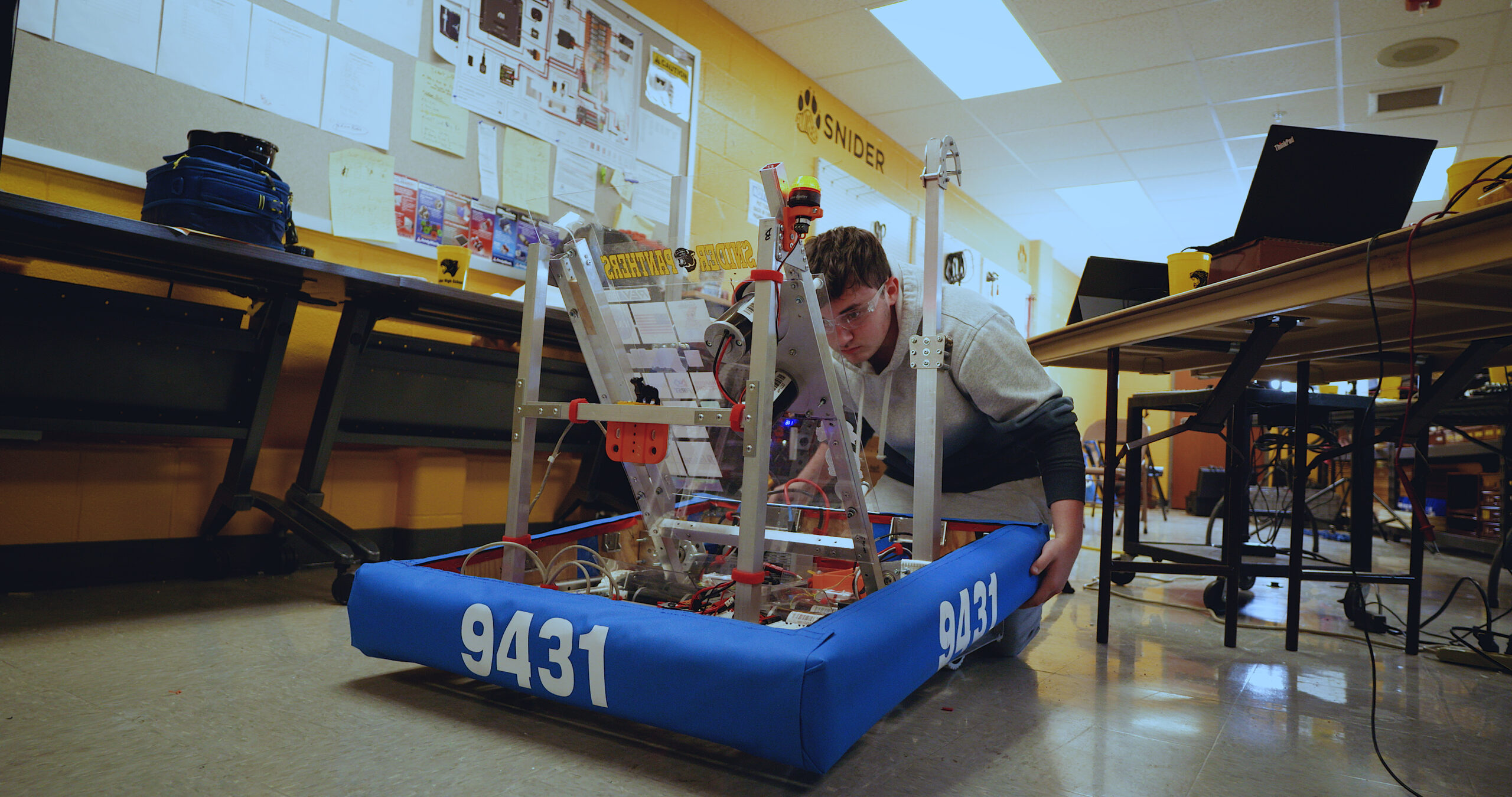 Teenager moving a robot